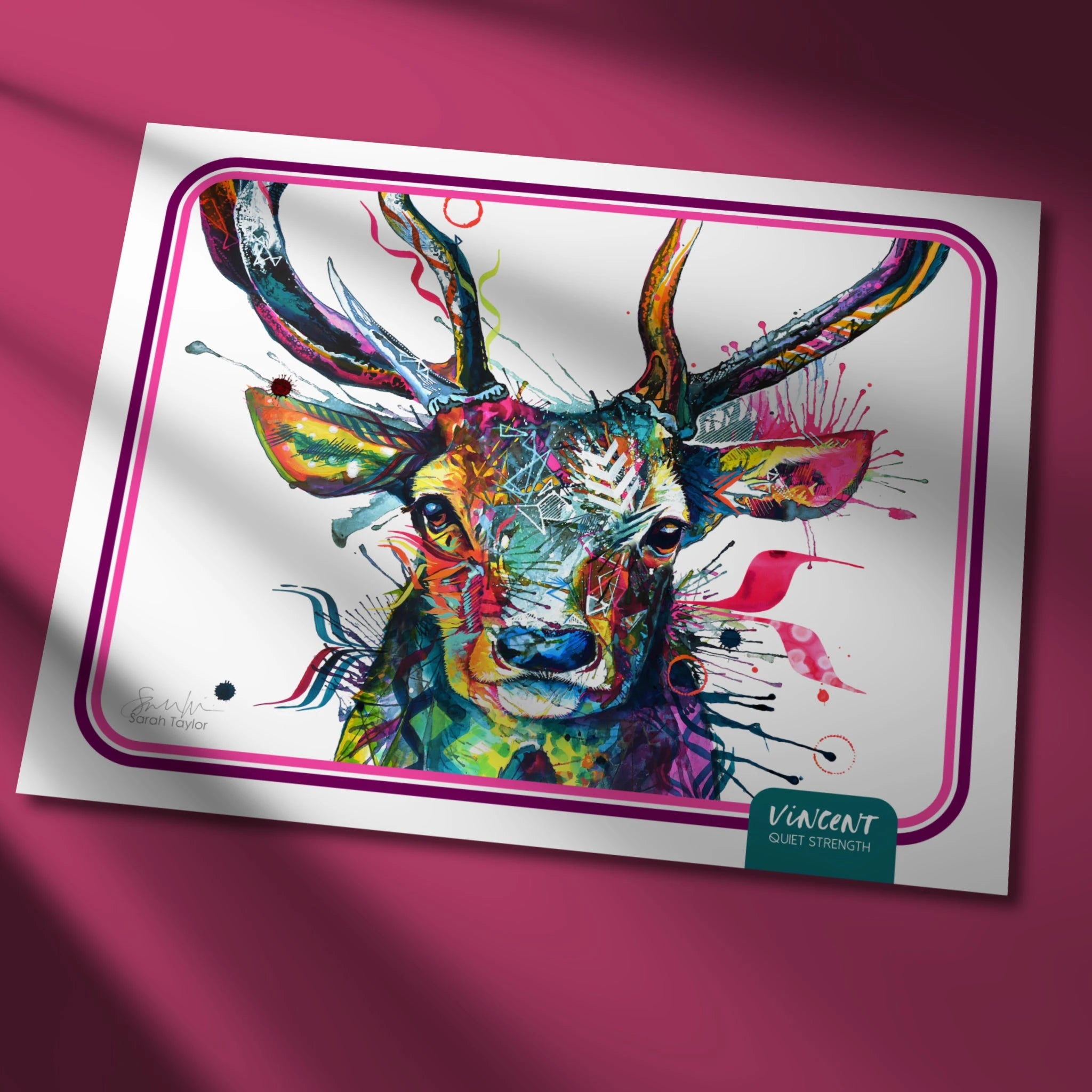 Colourful deer painting on a white card with a pink border against a pink background