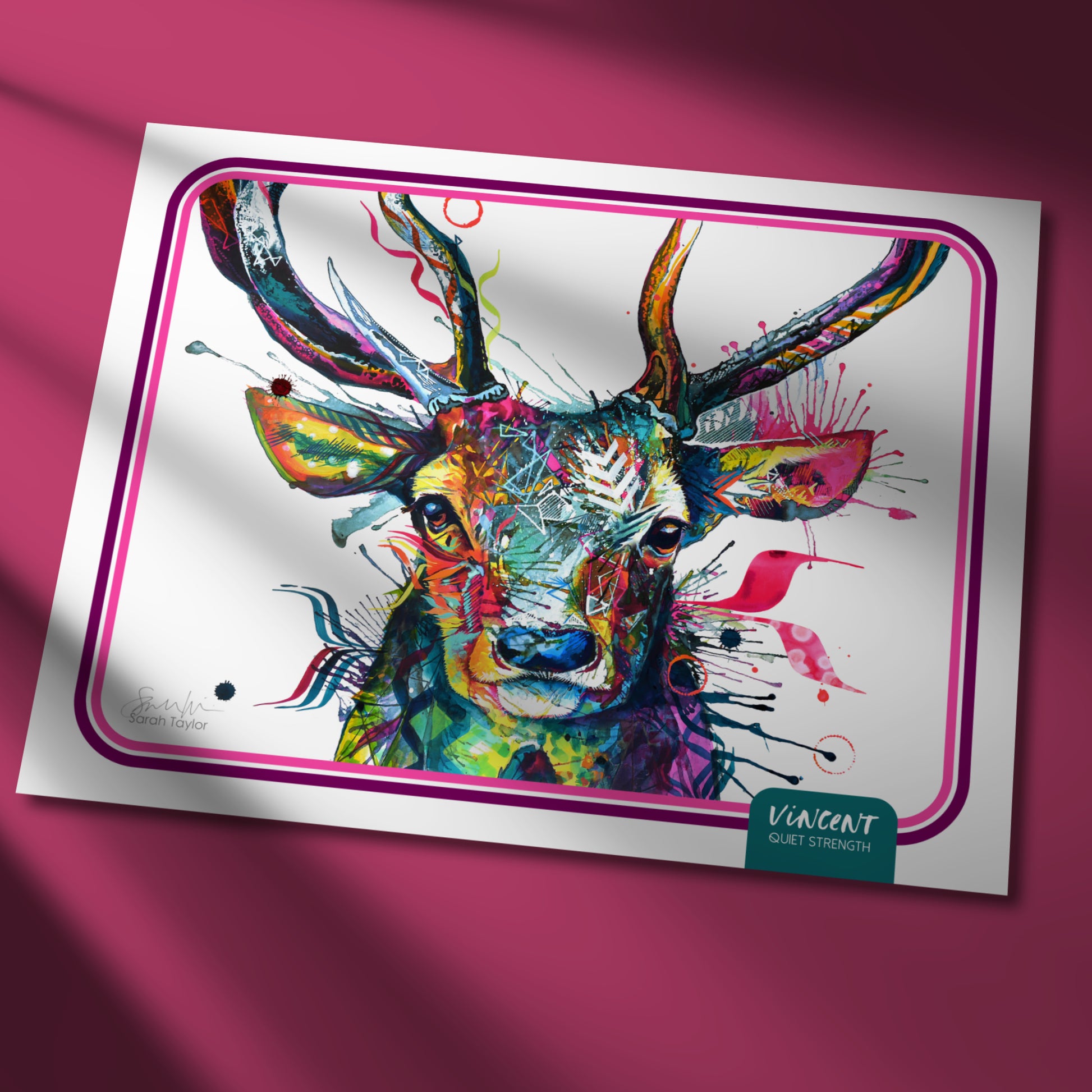 Colourful deer painting on a white card with a pink border against a pink background